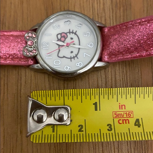 This is a Hello Kitty analog watch with a sparkly pink band and a jeweled bow - Picture 5 of 7